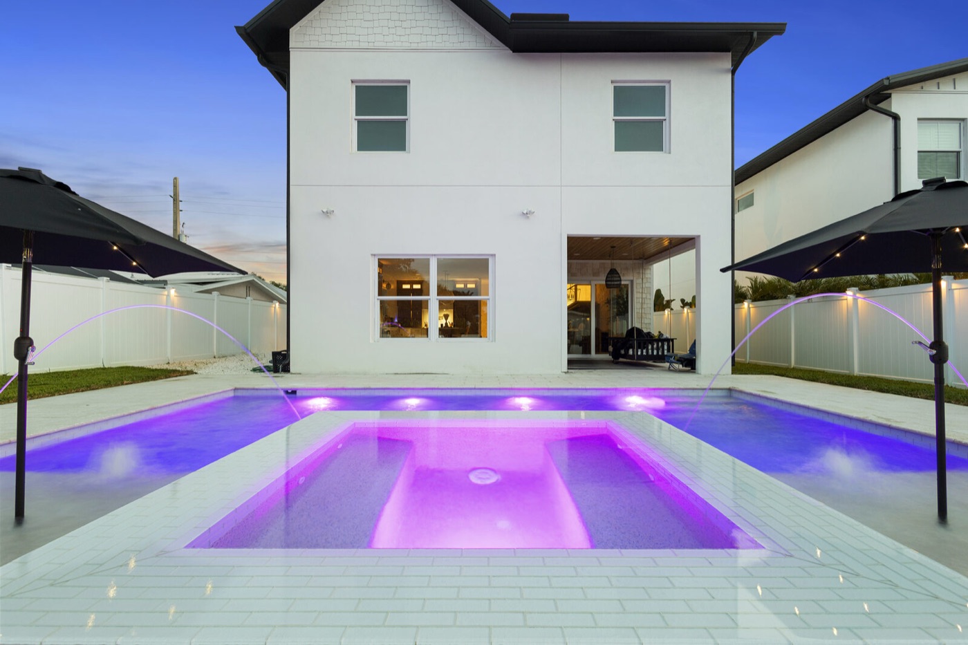 Modern pool lit at twilight